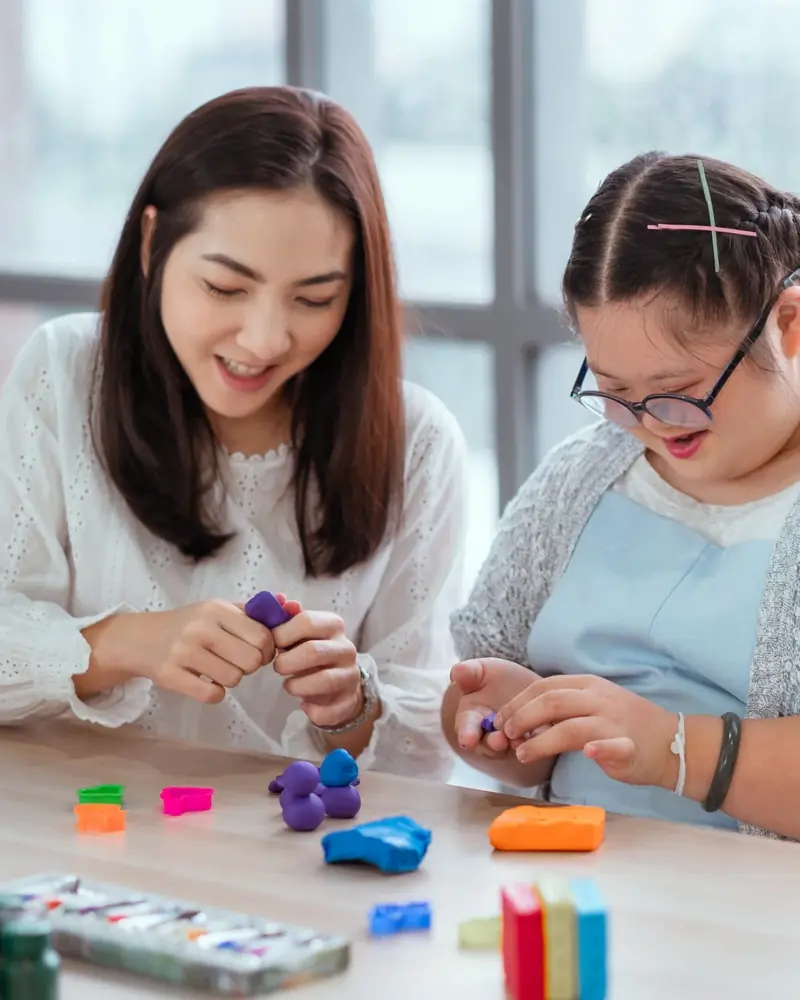 A caregiver and client enjoying a creative activity together