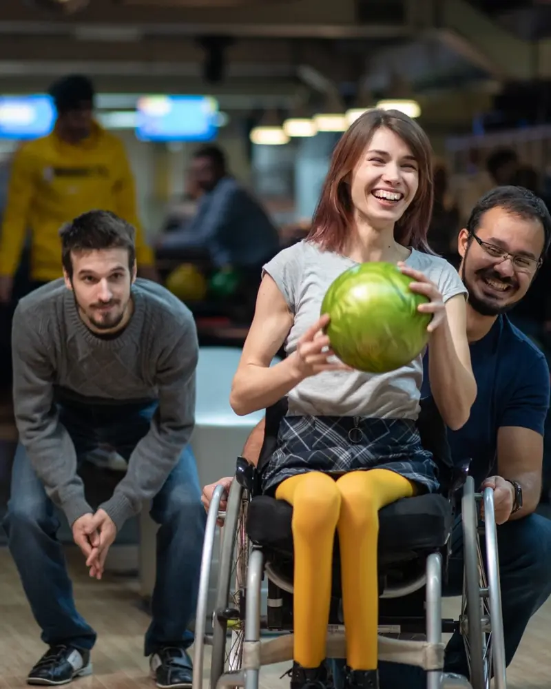 Friends enjoying an accessible bowling activity together